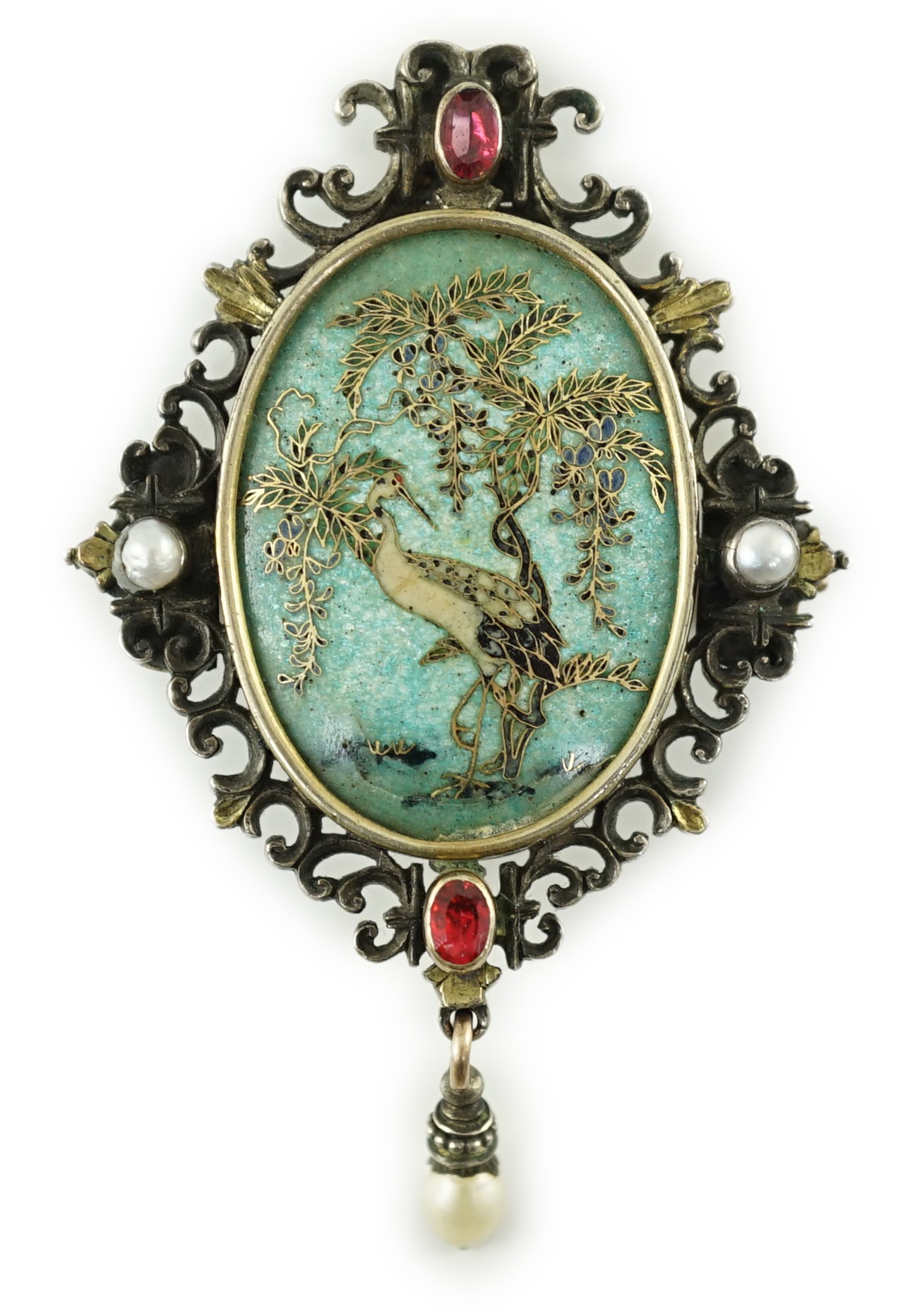 A Victorian oval gold, silver and cloisonné enamelled locket pendant, worked with a heron beneath wisteria, within a border mounted with pearls and foil backed garnets, the reverse inscribed and dated 1886